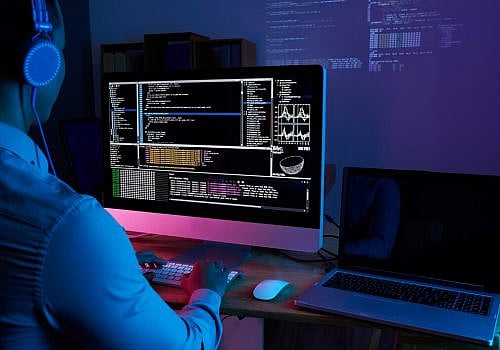 it-specialist-checking-code-computer-dark-office-night_1098-18699