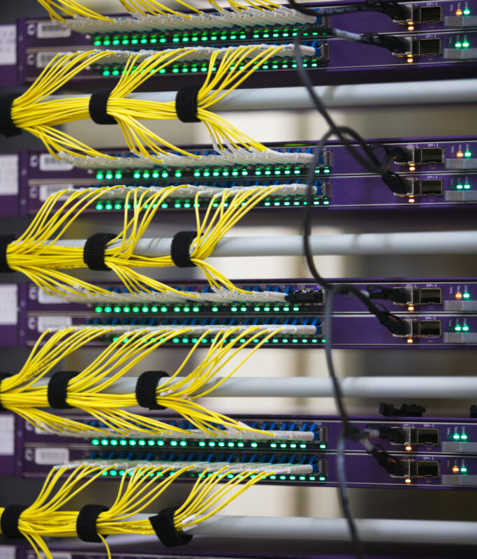 Fiber optic cables and routers in a communications data center.